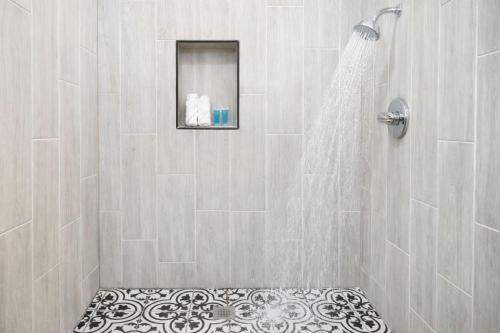a bathroom with a shower with a shower seat in it at West Philly Suites in Philadelphia