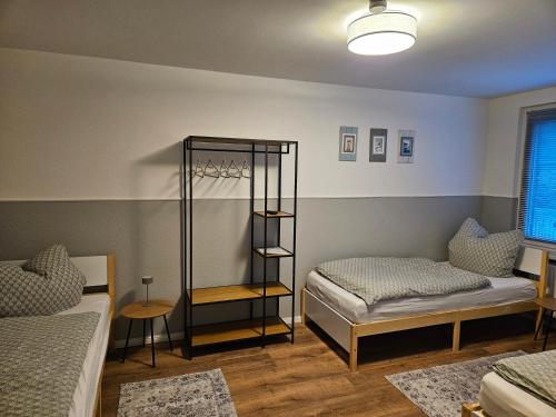 a room with two beds and a shelf in it at Fewo Kirch Jesar in Kirch Jesar