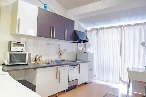 a kitchen with a counter top and a microwave at Ebi屋 in Osaka