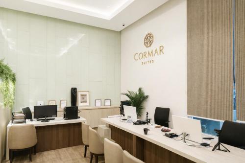 a lobby with desks and chairs with computers on them at Cormar Residences Kuala Lumpur in Kuala Lumpur