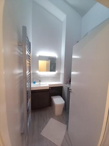 a bathroom with a toilet and a sink and a mirror at Lundy Views in Northam