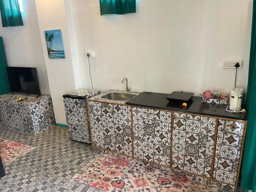 a kitchen with a sink and a counter top at Art Resort Goa in Palolem