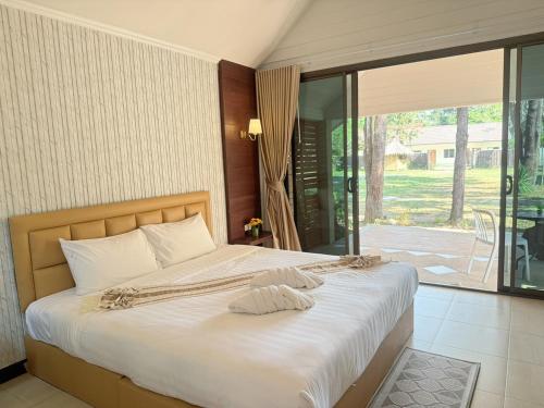 a bedroom with a bed and a sliding glass door at Green Haven Villas in Krabi