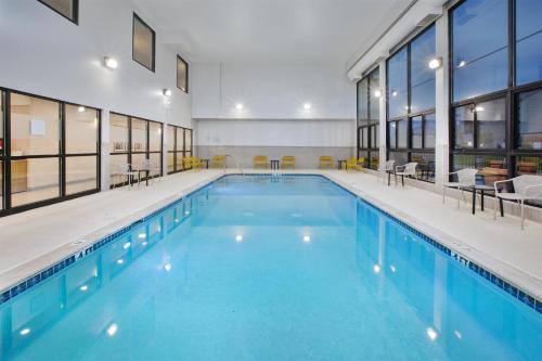 a large swimming pool with blue water in a building at Hampton Inn Detroit/Belleville-Airport Area in Belleville