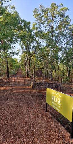 a yellow sign sitting in the middle of a park at The Ridge Retreat on Litchfield in Rum Jungle Station