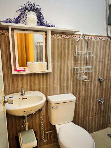 a bathroom with a toilet and a sink at Serenity Stay in General Santos