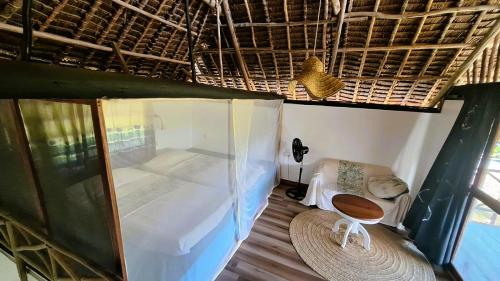 a room with a bed and a chair in a room at Kipepeo Beach and Village in Dar es Salaam