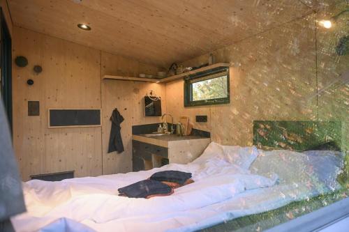 a large bed in a room with a sink at Green&Tiny Spot Wolfenbüttel Okeraue - Sleep Space 2 in Wolfenbüttel