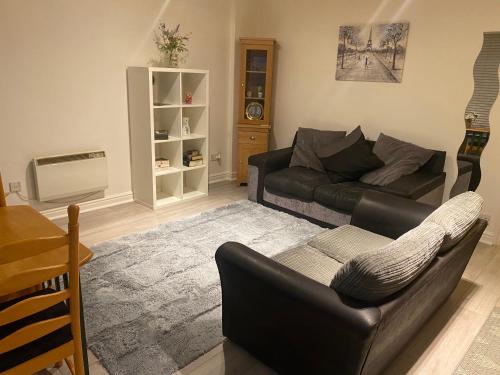 a living room with a couch and a table at 4 Castle Walk in Stansted Mountfitchet