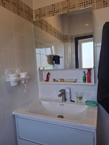 a bathroom with a sink and a mirror at Villa Meerblick in Ban Map Khangkhao