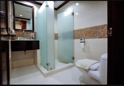 a bathroom with a shower and a toilet and a sink at Paradise Station 3 Garden Boracay Resort by JustGoFun in Boracay