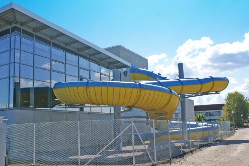a water slide in front of a building at Blockhaus mit grosser überdachter Terrasse in Damp