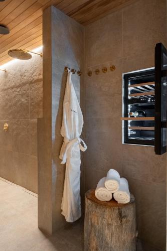 a bathroom with a shower with towels and a wooden ceiling at Inai Haven in Ivalo