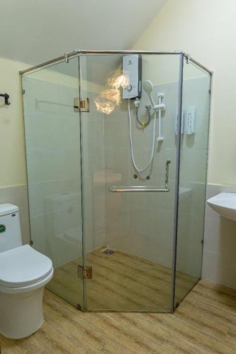 a shower stall in a bathroom with a toilet at Olive Villa in Khu Chi Lăng