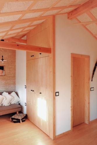 a room with a wooden door and a bed at Refúgio House Natura Moinho de Água - Eco House in Guimarães