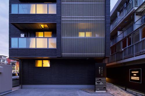 a black building with windows and a sign in front of it at ラディアントイン岡山駅西口 in Okayama