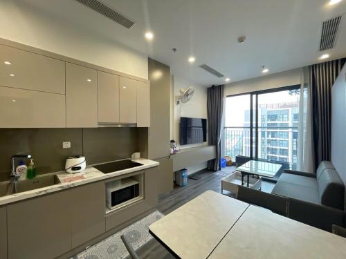 a kitchen and living room with a couch and a table at Dulichxanh3026 in Gia Lâm Pho