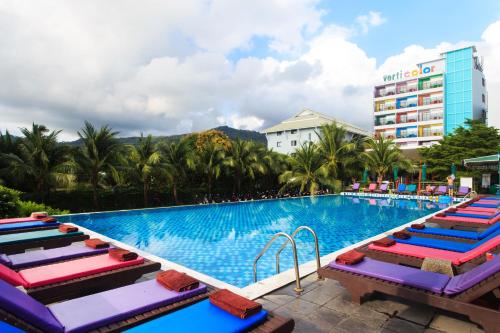 a pool at a hotel with lounge chairs at Samui Verticolor in Chaweng