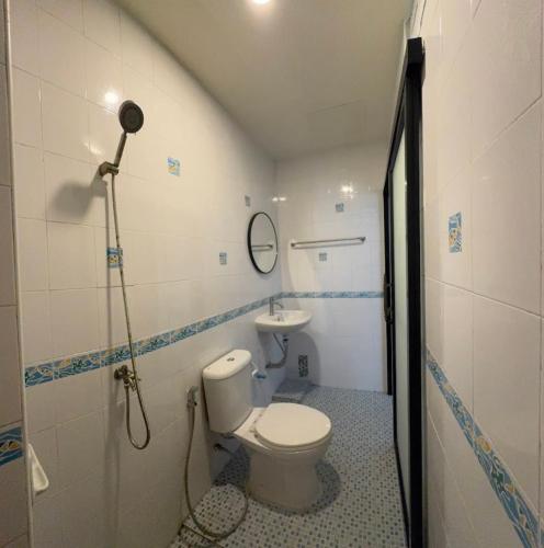 a bathroom with a toilet and a sink at Sleep at Saithai in Ban Sai Thai