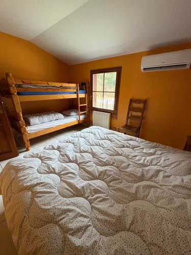 a bedroom with a large bed and a window at Chalet au bord du lac de Longemer in Xonrupt-Longemer