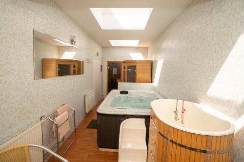 a bathroom with a tub and a sink at Hotel Dominika in Bratislava