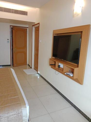 a living room with a flat screen tv on a wall at HOTEL SALEM CASTLE in Salem