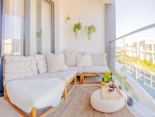 a living room with a couch and a table at Palmera - Spacious Studio with Pool View in Vasilia