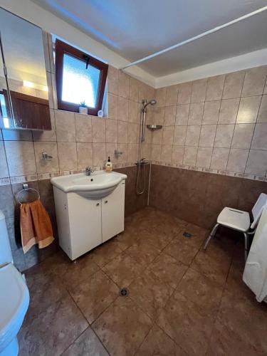a bathroom with a sink and a shower and a toilet at Villa Tunley in Razvalini Balchikioy
