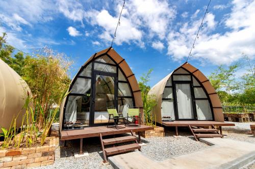 a couple of glass igloos in a garden at Nadi Glamping Suites, Auto-City in Perai