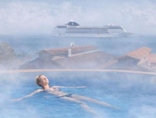 a woman in a swimming pool with a cruise ship at Sunset Destination Hostel in Lisbon