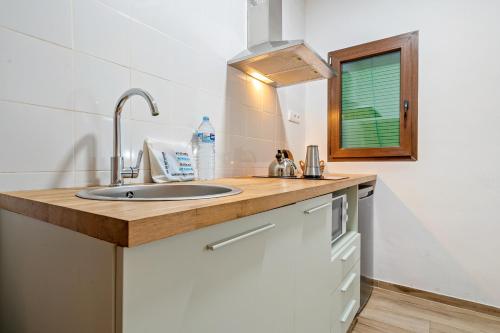 a kitchen with a sink and a window at FORUM EXPERIENCE Adults Only in Tarragona