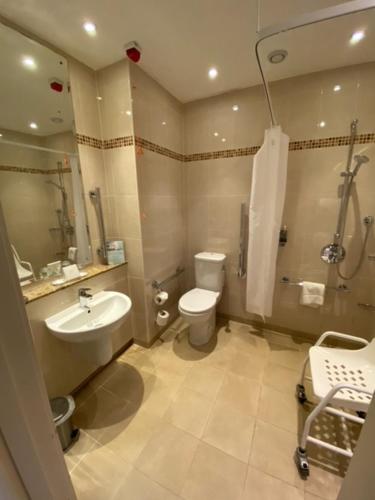 a bathroom with a sink and a toilet and a shower at Macdonald Linden Hall Hotel, Golf & Spa in Longhorsley