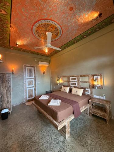 a bedroom with a bed and a coffered ceiling at Wilson's Place in Hiriketiya