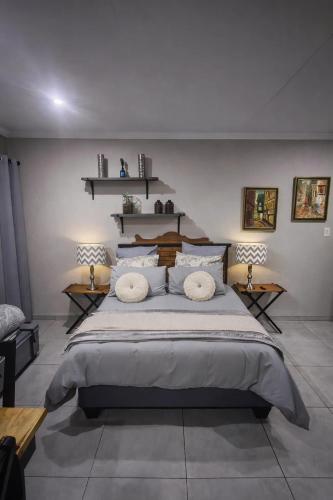 a bedroom with a large bed with two pillows at ColtsRest in White River