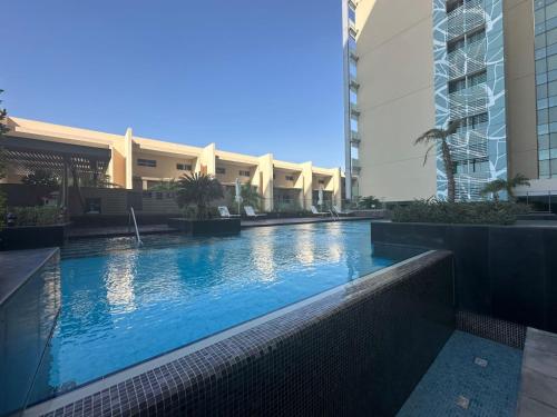 a swimming pool in the middle of a building at Silk Valley - Al Raha Luxury 1B with Direct Beach Access in Abu Dhabi