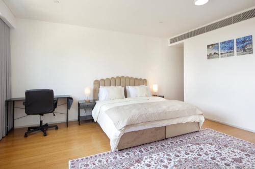 a bedroom with a bed and a desk and a chair at Silk Valley - Al Raha Luxury 1B with Direct Beach Access in Abu Dhabi