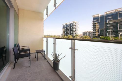 a balcony with a view of a city at Silk Valley - Al Raha Luxury 1B with Direct Beach Access in Abu Dhabi