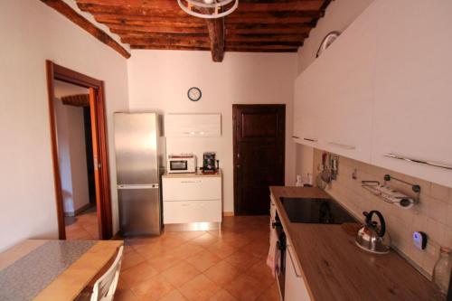 a kitchen with a stainless steel refrigerator and white cabinets at Casa Carlo in Rio Marina