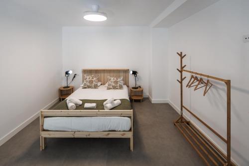 a bedroom with a bed in a room with a staircase at Apartamentos Cayetana in Badajoz