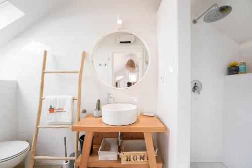 a bathroom with a sink and a mirror at Charming design house in Montijo with garden - 41 in Montijo