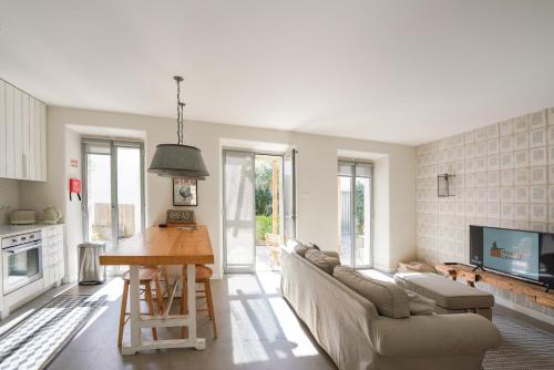 a living room with a couch and a table at Charming design house in Montijo with garden - 43 in Montijo