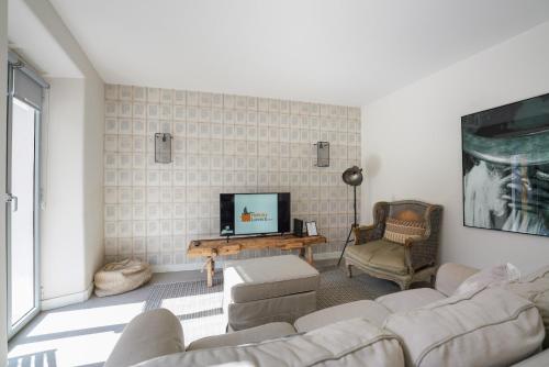 a living room with a couch and a tv at Charming design house in Montijo with garden - 43 in Montijo