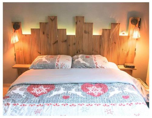 a bedroom with a large bed with a wooden headboard at la villa "Loane" à St Paul trois Chateaux in Saint-Paul-Trois-Châteaux