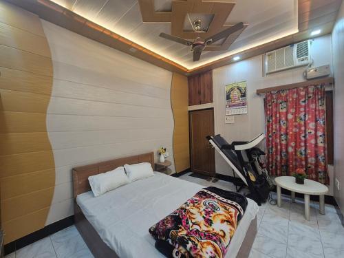 a bedroom with a bed and a ceiling fan at Triveni Bliss in Prayagraj
