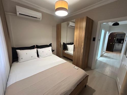 a bedroom with a large white bed in a room at No 8 Suite in Alanya