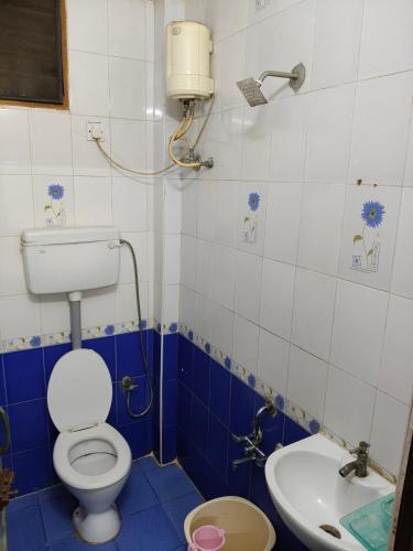 a bathroom with a toilet and a sink at SMS GRAND inn in Chennai