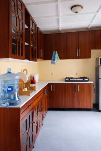a kitchen with wooden cabinets and a counter top at COLIBRI VILLA City Center in Gisenyi