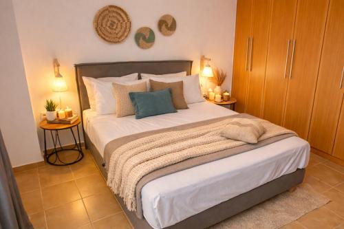 a bedroom with a large bed with two side tables at Natural view villa with private pool in Skouloúfia