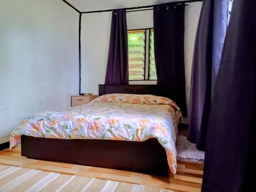 a bedroom with a bed and a window at LOwayalailaiSTAY in Wayasewa Island
