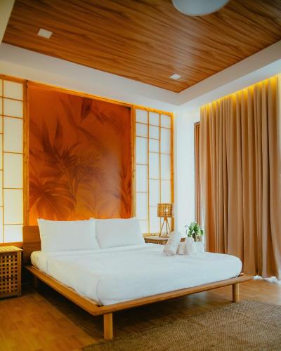 a bedroom with a large bed in a room at Villa Kaiyo La Union in Bacnotan